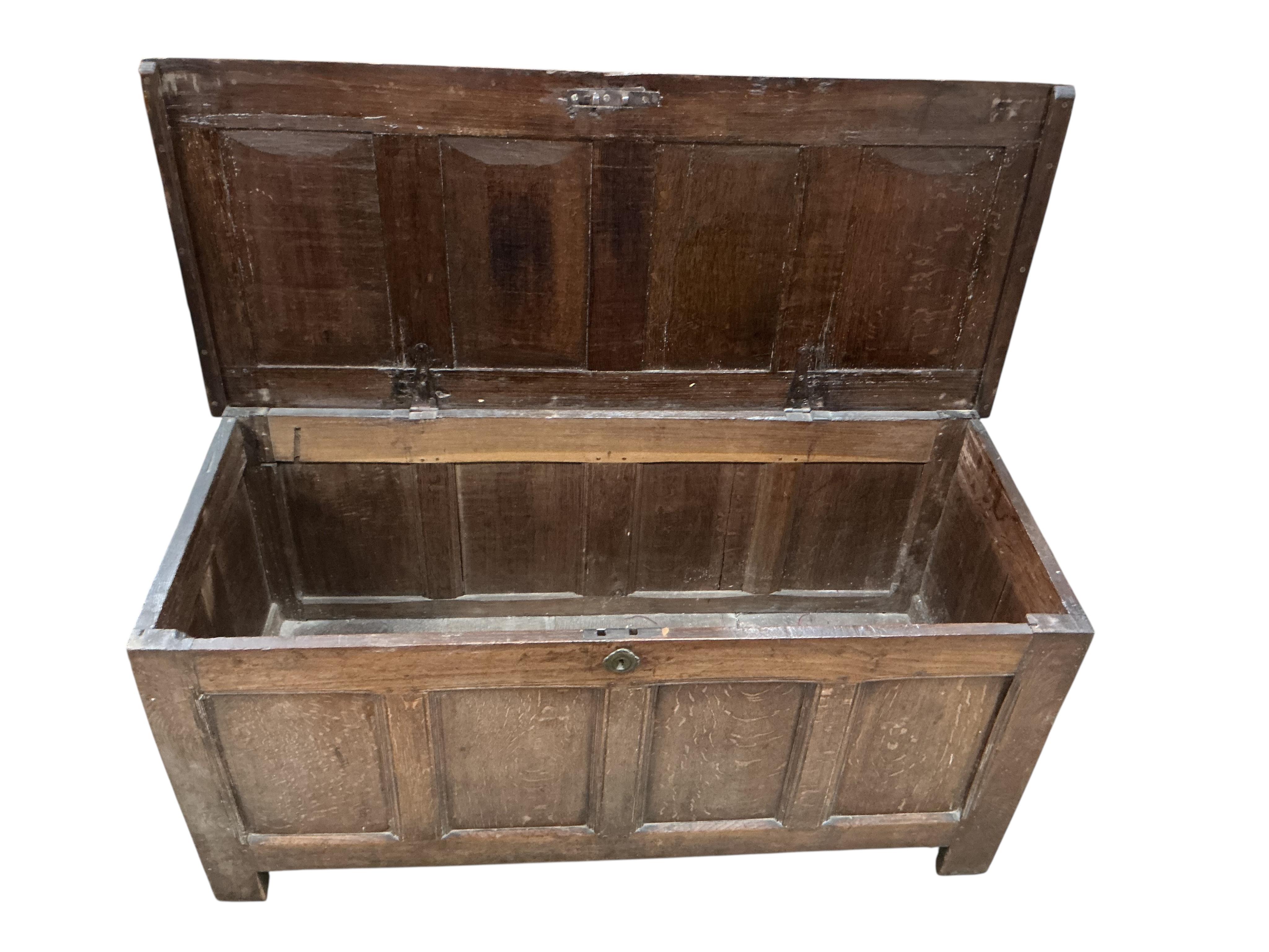 An 18th century panelled oak coffer, width 130cm, depth 55cm, height 61cm